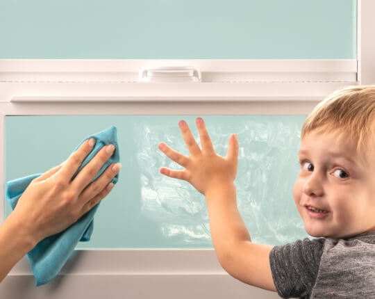 Child leaving handprints on window my mother cleans it