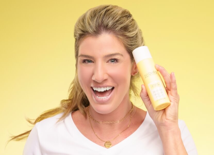 Woman holding daily moisturizer