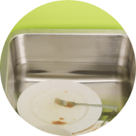 Soiled dishes soaking in sink.