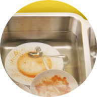 Soiled dishes soaking in sink.
