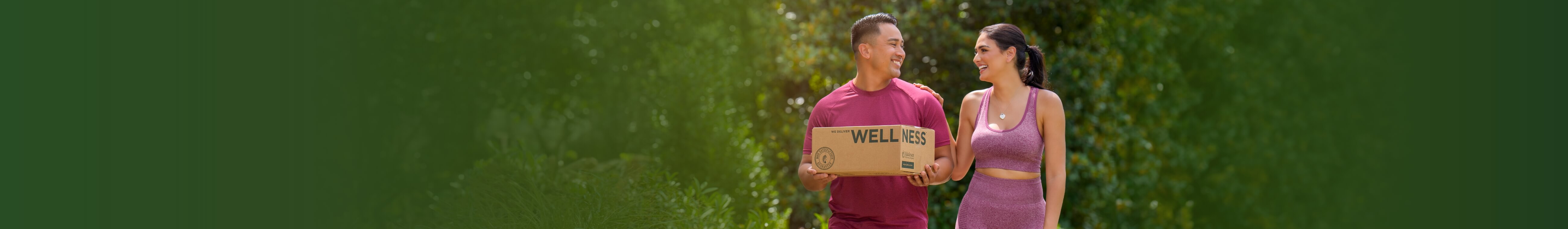 Man and woman holding Wellness box
