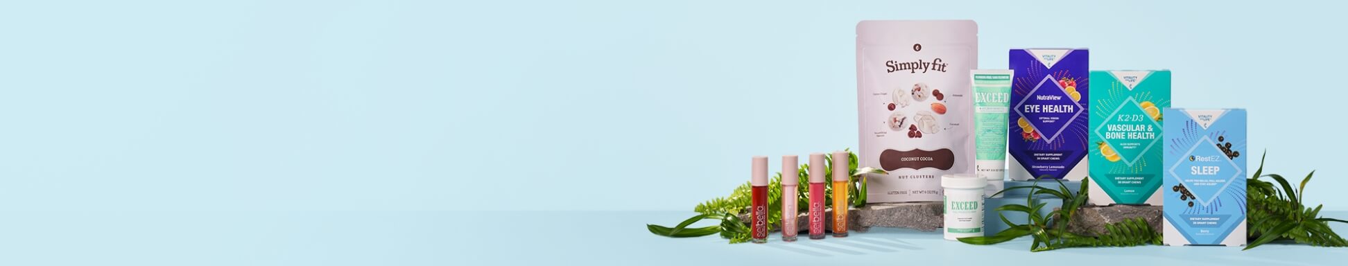 A collection of health products on a light blue background, including supplements, lip balms, and creams. Green foliage adds a fresh, natural touch.