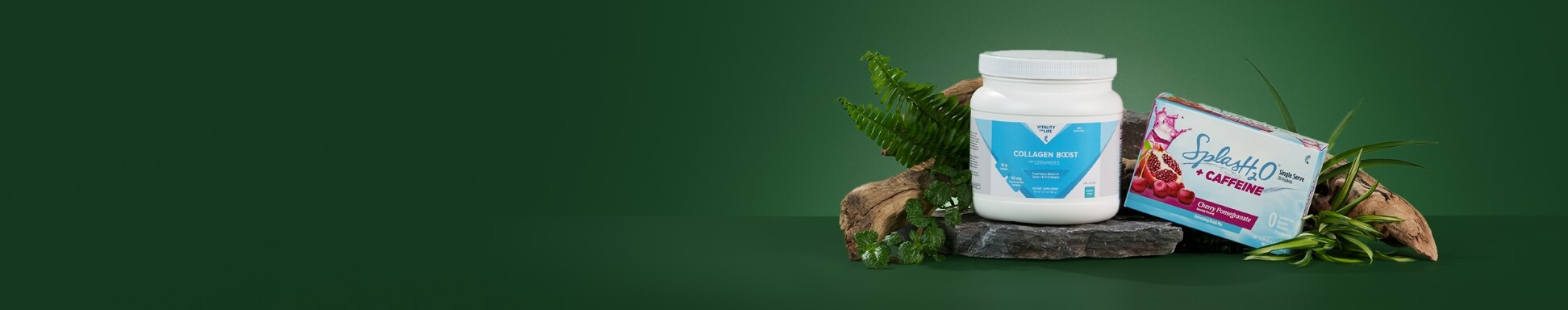 Collagen Boost and SplasH2O + Caffeine sit on a stone, surrounded by driftwood and green leaves, against a dark green background.