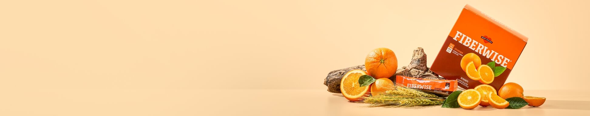Orange Fiberwise box with oranges, wheat, and driftwood on a light orange-tan background.
