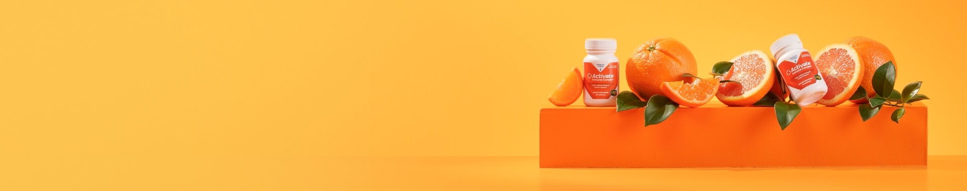 Activate Immune Complex 2-Pack on an orange box with oranges and leaves on a light orange background