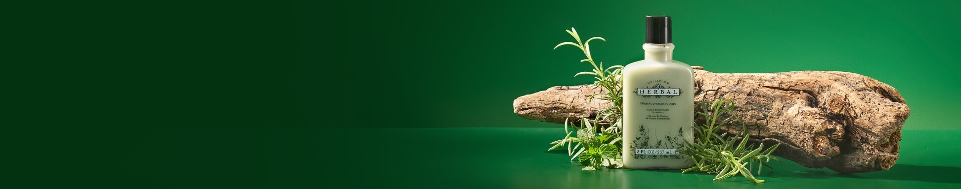 Herbal shampoo bottle in front of a log with fresh green herbs. Set against a vibrant green background, conveying a natural, earthy feel.