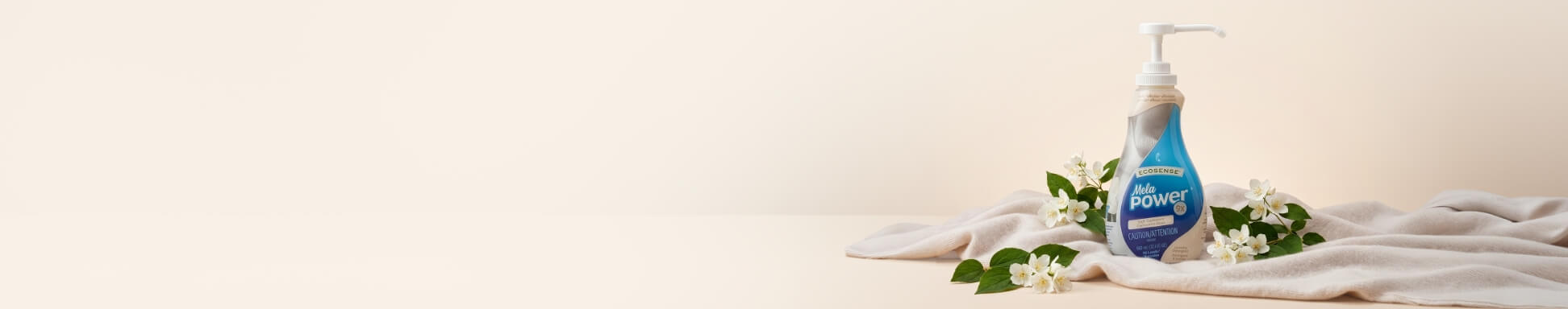 Melapower surrounded by white flowers posed on a white blanket on a cream backdrop