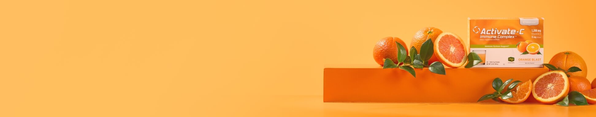 Activate-C surrounded by whole and sliced oranges with green leaves, creating a bright, fresh, energetic scene.