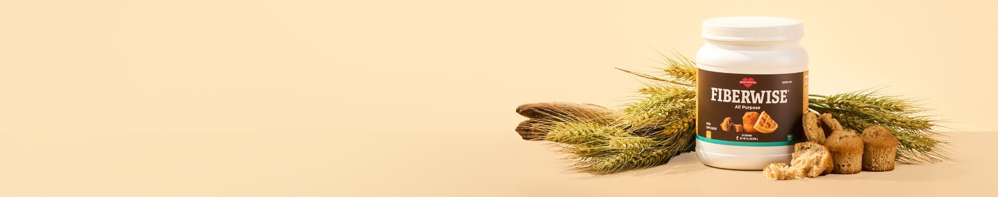 A canister of FiberWise All Purpose surrounded by stalks of wheat and baked muffins.
