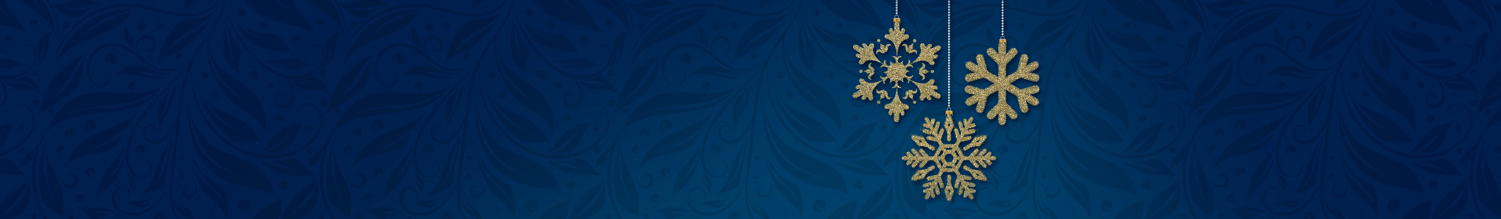 Gold glitter snowflake ornaments hanging against a deep blue decorative background.