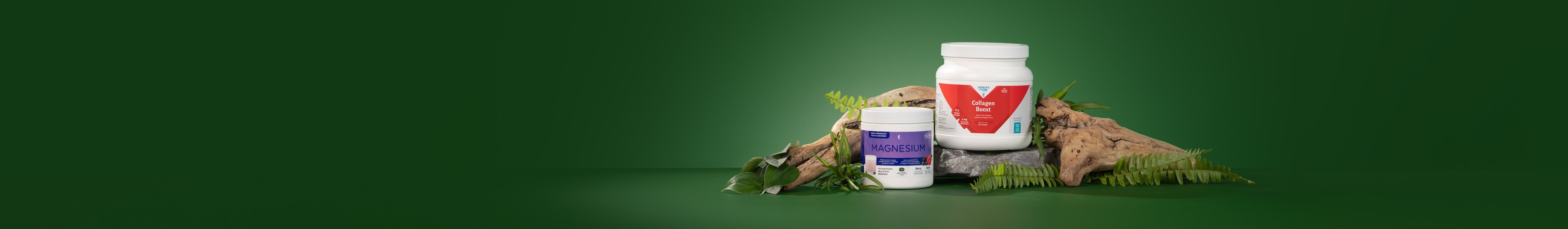 Collagen Boost and Melaleuca Magnesium surrounded with plants and driftwood against a green background