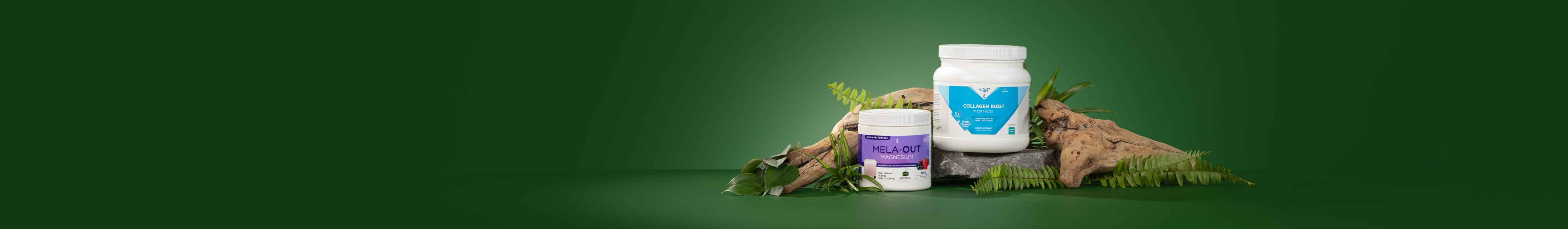 mela-out and collagen boost  surrounded with plants and driftwood  against a green background