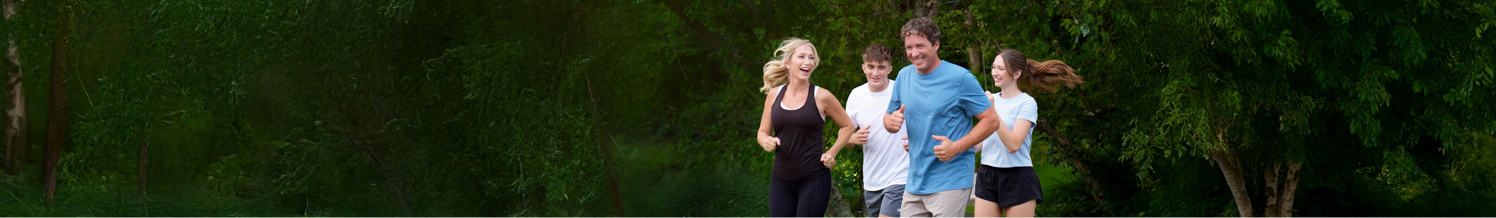 A smiling family jogging together.
