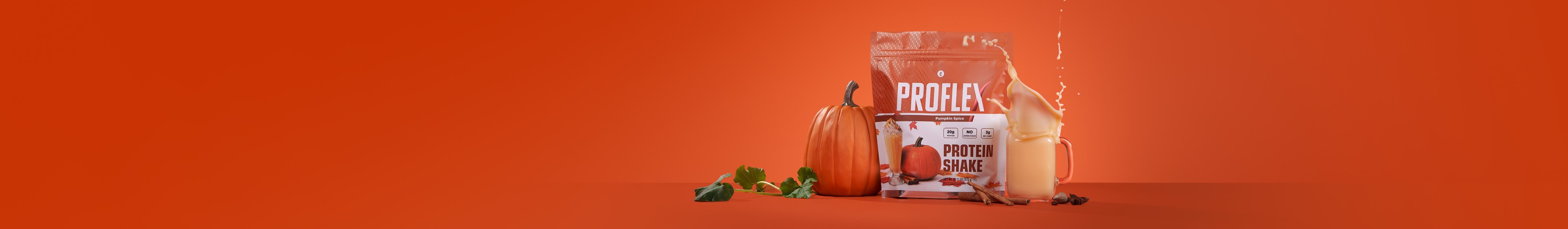 A bag of Proflex Pumpkin Spice Protein Shake beside a pumpkin, a creamy shake, and cinnamon sticks.