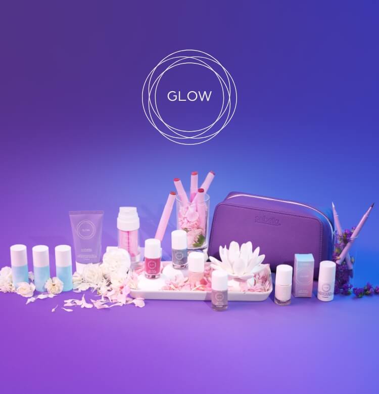 A layout of various Girls' Night In products surrounded by flowers and a white towel.