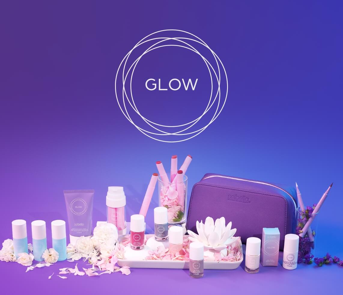 A layout of various Girls' Night In products surrounded by flowers and a white towel.